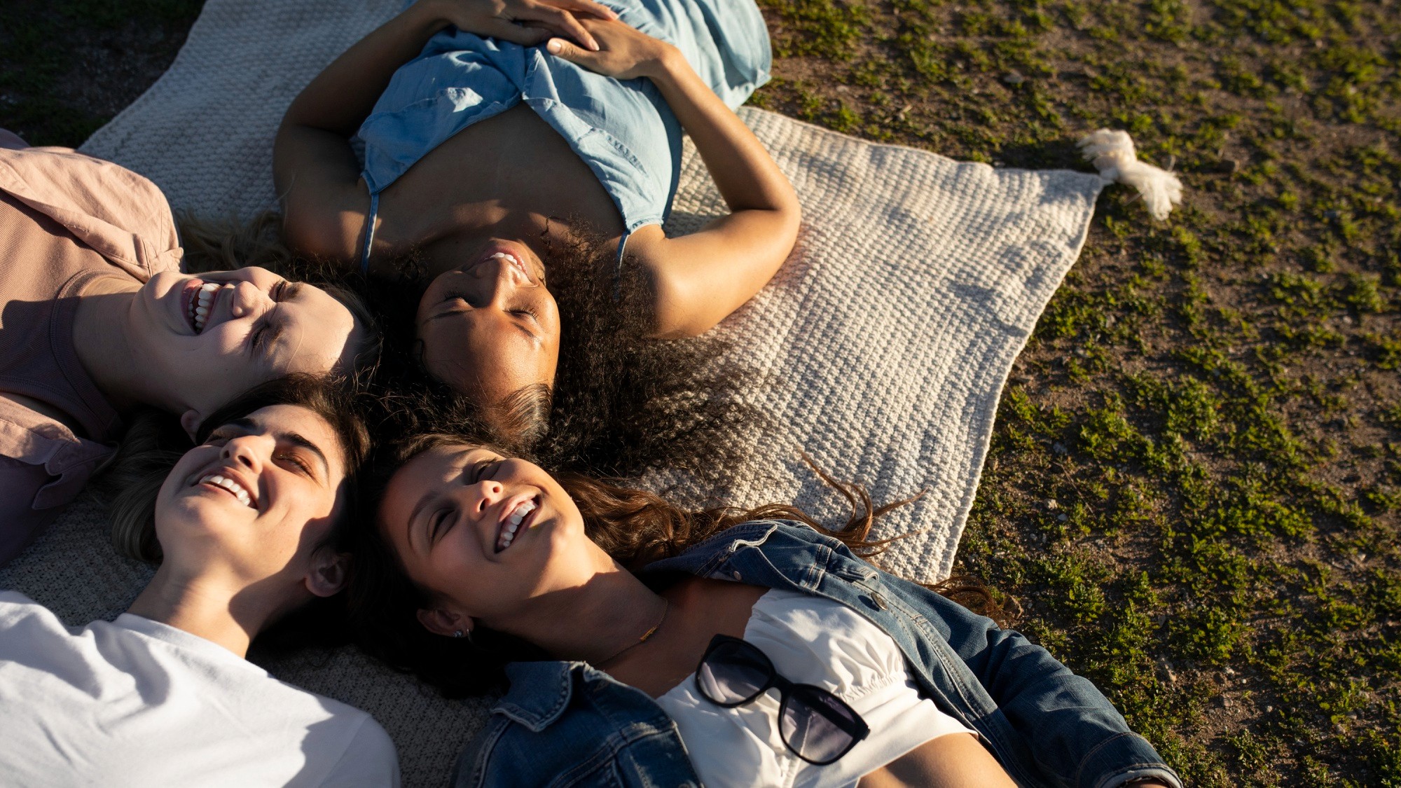 Countries — four friends lying down laughing