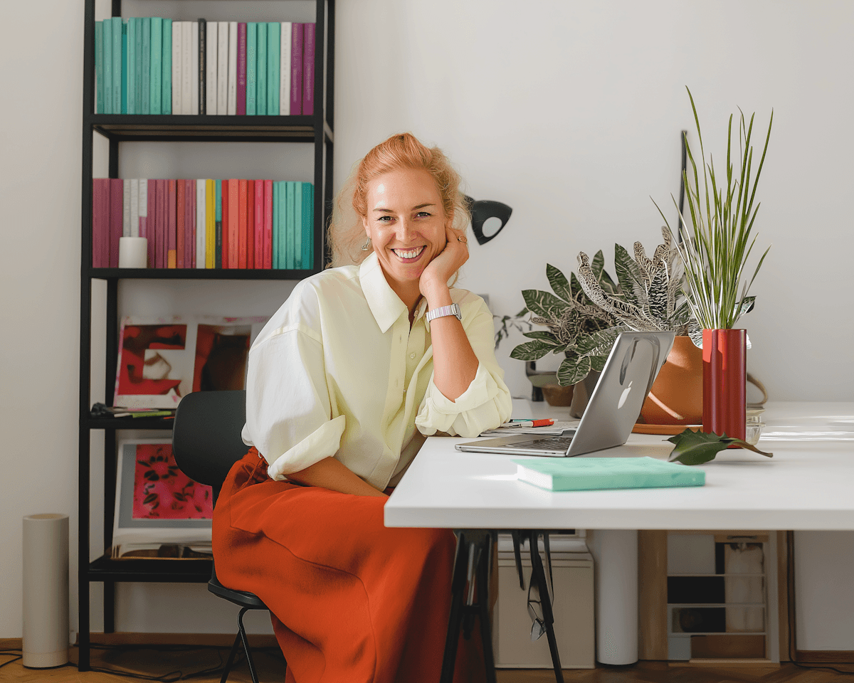 About — woman at desk with plants