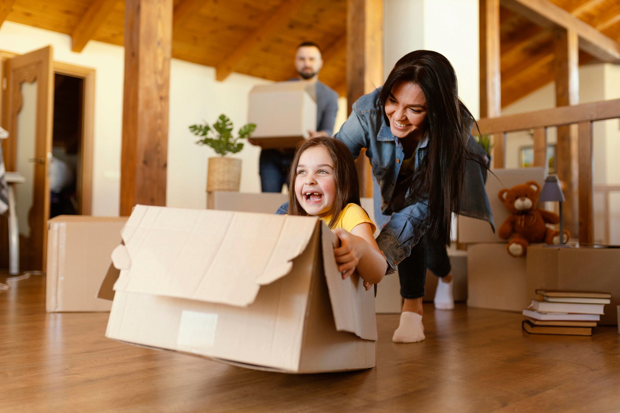 Blog — child in moving box with parents