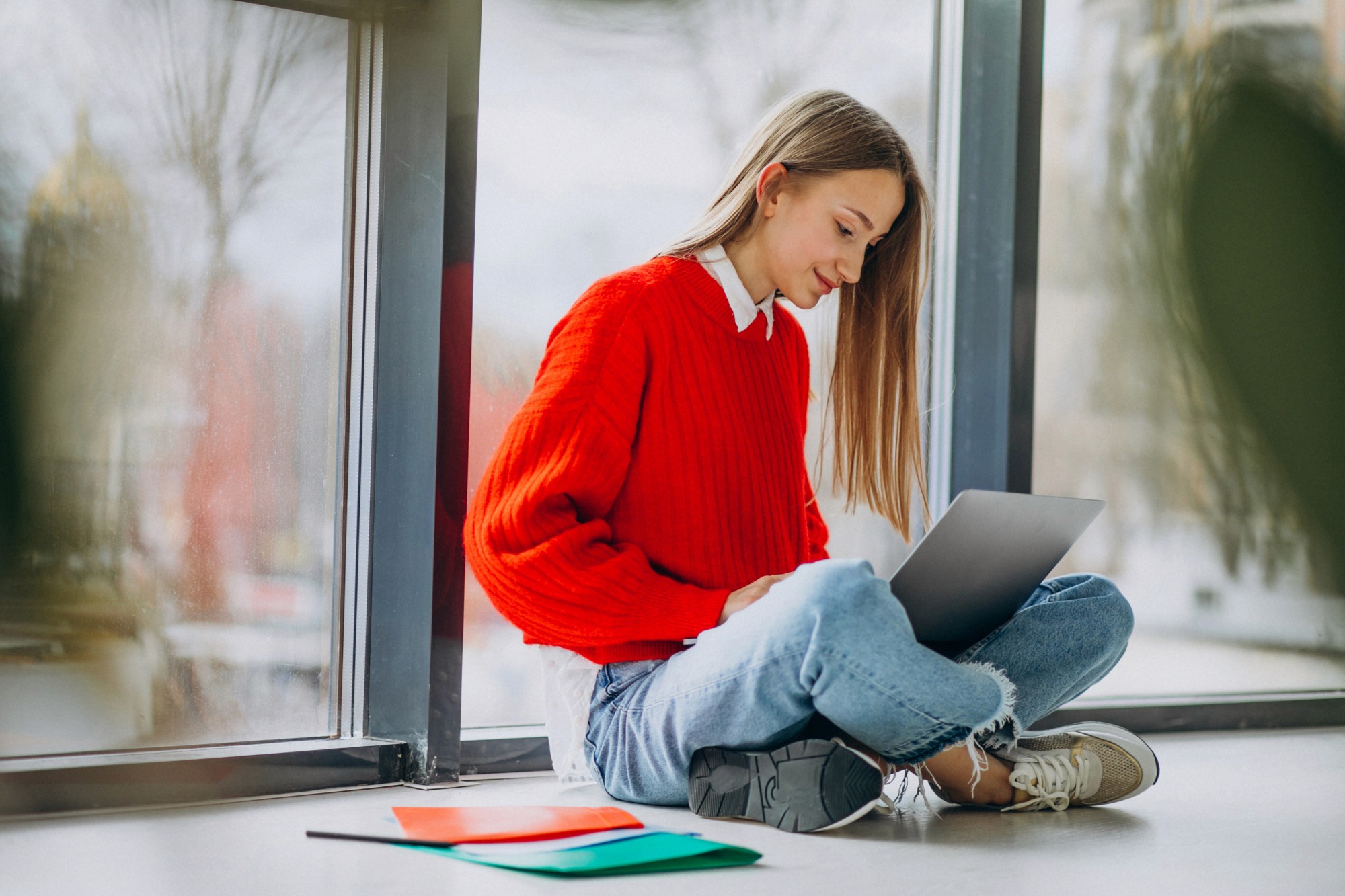 Blog — student with laptop by window