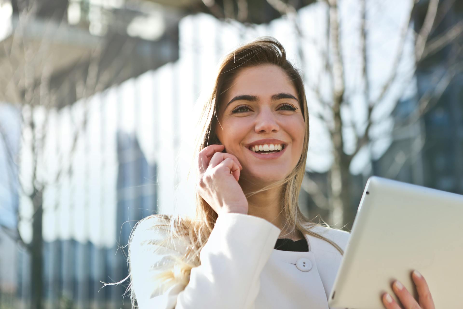Coaching — smiling woman on phone with tablet